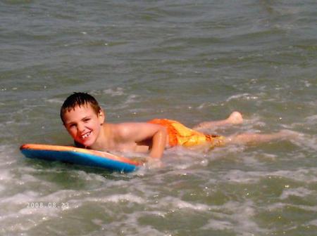 3rd son at beach with grandparents