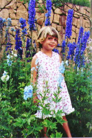 Emily-5 yrs standing in delphiniums in Breckenridge