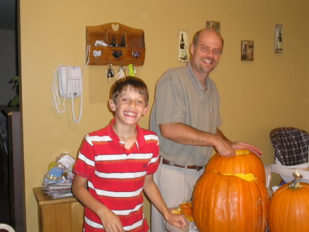 Scott and Erik carving pumpkins.