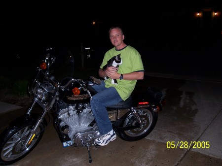 Doug sittng on Patti's Harley with Licorice