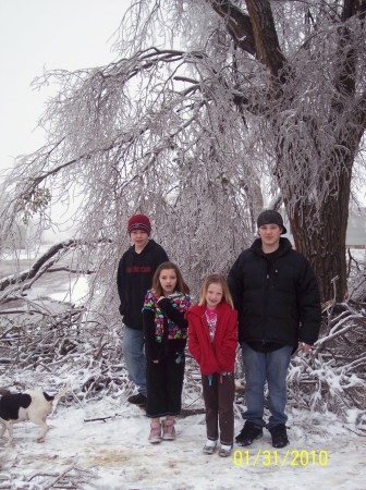 kids surrounded by broken trees