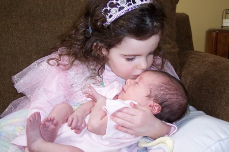 Sara kissing her baby sister Ella