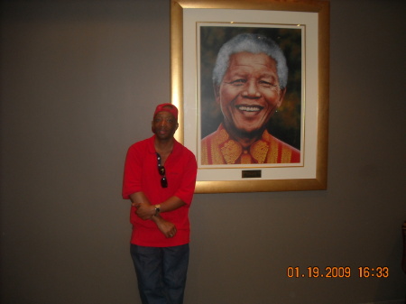 In front of a portrait of Nelson Mandela