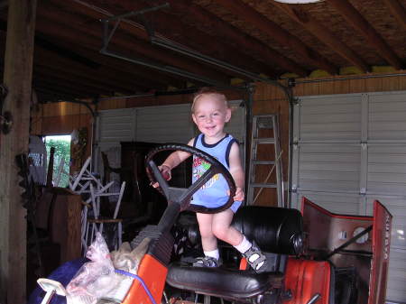 Grandma's Favorite boy driving the lawn mower.