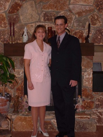 My late wife and I in front of our fireplace.