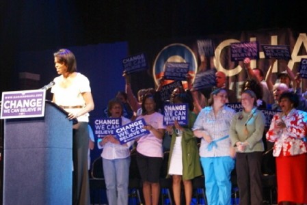 On stage behind Michelle Obama