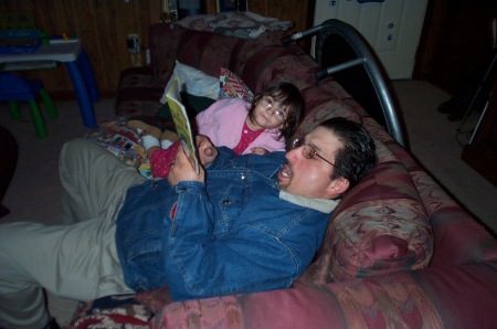 Daddy reading Daughter a book