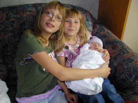 The 2 proud sisters, Shelby and Amanda with their new brother Daniel