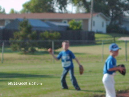My son playing baseball hes the one throwing the ball!