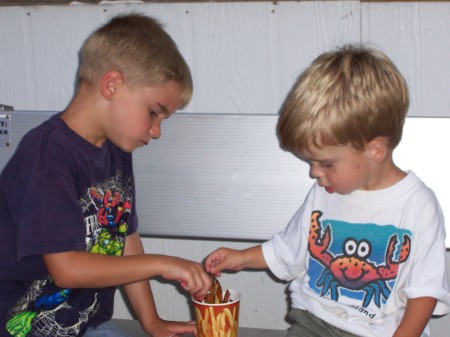 My boys sharing fries at the fair