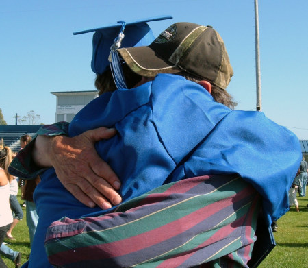 Johnny getting a congrats hug from grandpa