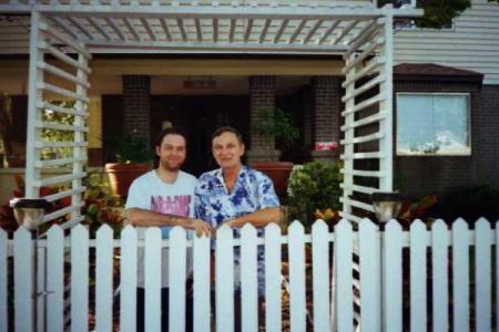 my son M.C. and husband Mike in front of home