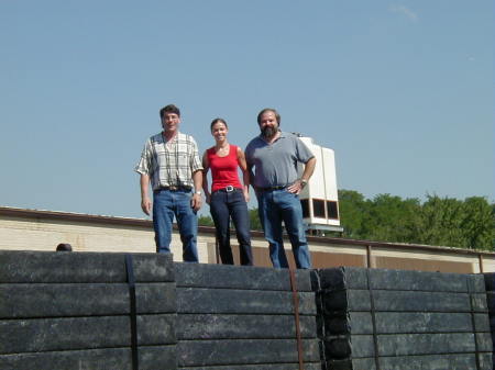Rich, Jen, and Tom on a mountain of recycled plastic ties
