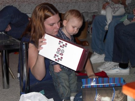 Alex and Mom opening gift from Daddy's family