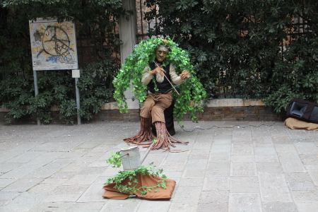 Young man playing a hand saw