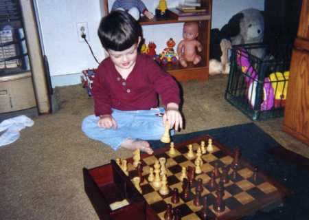 Blake playing with daddy's chess set