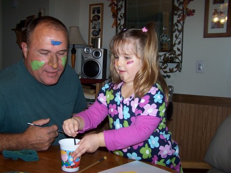 Katelynne, age 5, facepainting with Grandpa
