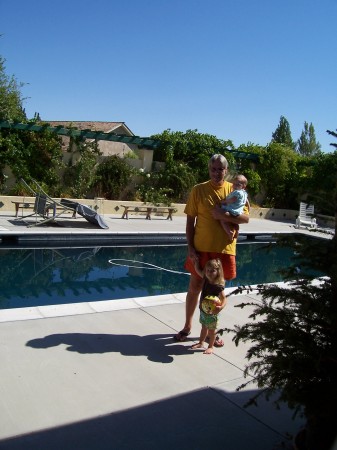 Grandpa and two of the babies by the pool