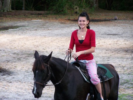 my daughter katrina  on her horse genny
