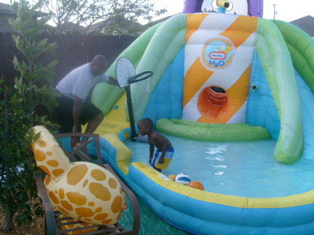 PLAYING IN THE BACK WITH HIS POOL