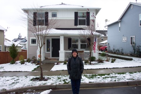 Annette in front of her house