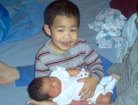 Edwin holding his new baby brother Albert