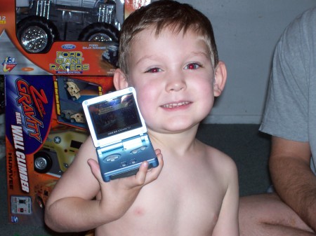 My youngest son on X-Mas day 2005 with his Game Boy.