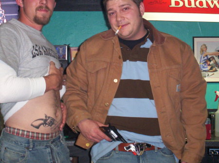 my son travis on the left showing off his tattoo