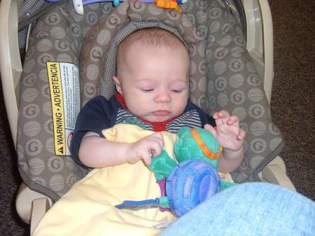 mason playing with a toy for the 1st time