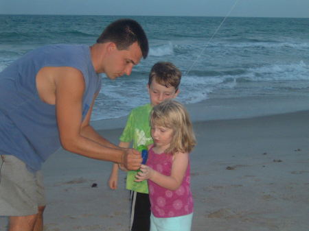 My husband David with the kids at the beach.