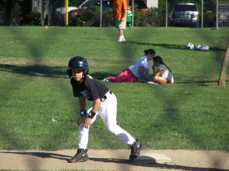 Caden playing baseball