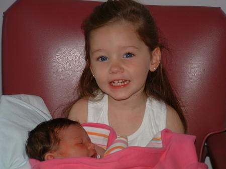 Hannah holding her new baby sister for the first time in the Hospital-Aug 2003