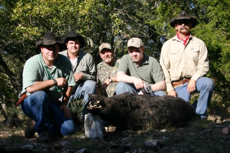 My son Ryan's first Boar. Pictured with the guys. Ryan is holding the gun.