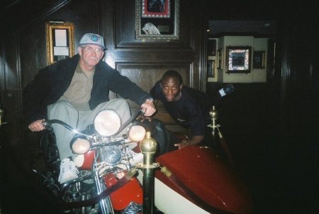 my hubby  sitting on motorcycle and his friend from his troop