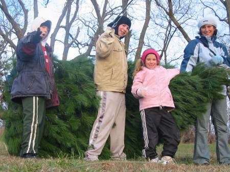 my kids and I cutting down the Christmas tree