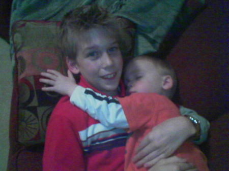 My eldest son, holding my youngest son, asleep