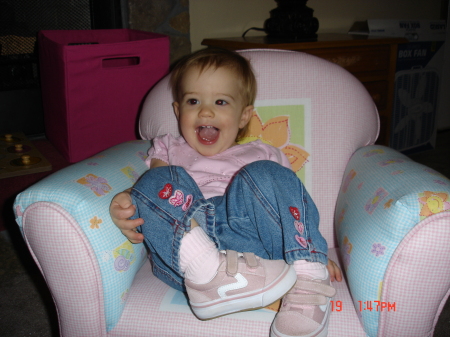 Anna in her new chair. Anna's also walking now.