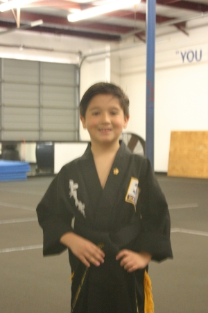 My son Joshua receiving his black belt
