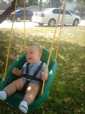 Aaron swinging in the front yard