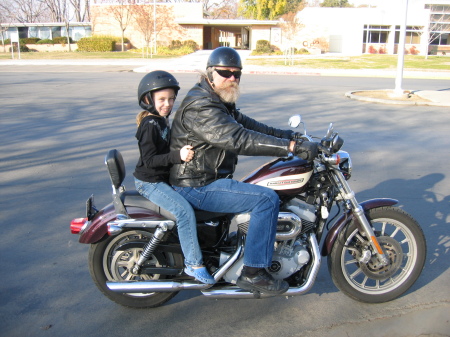 My daughter, Maddie, riding a Harley with her Grandpa Bob