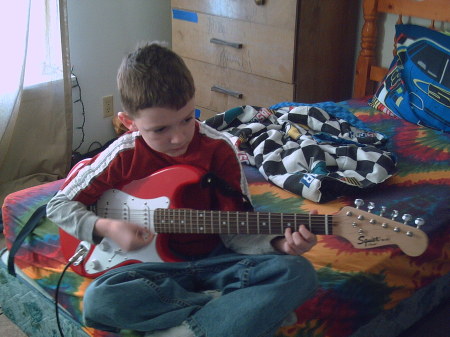 my son playing his guitar