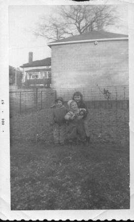 My sister, brother and I in our backyard.