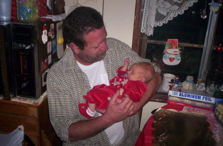 my husband scott and our new gandbaby on christmas