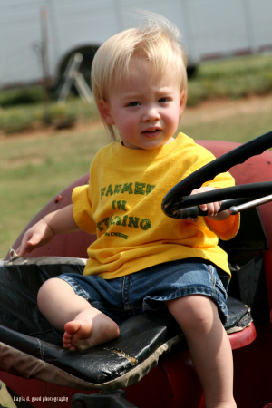 My grandson Landon on my tractor