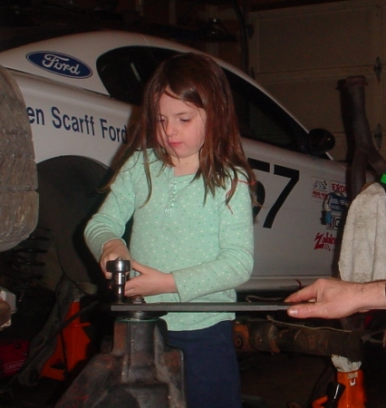 Christina helping Dad with the racecar