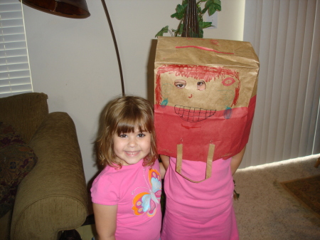 Maura, my middle daughter, with her bagged older sister!