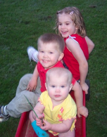 Caitlin, Chase and baby Paige playing with Nana's red wagon