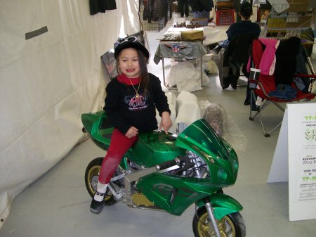 daddys girl showing off her bike at the show