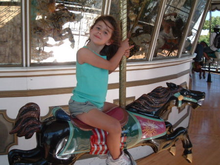 Daughter on merry go-round. Great America 2007