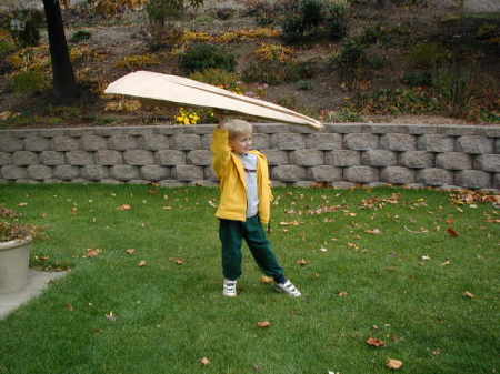 Jacob trying out the paper airplane we made together.